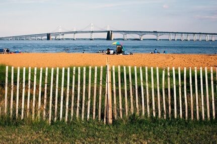 A sandy beach with a view of the Gov. William Preston Lane Jr. Memorial Bridge.