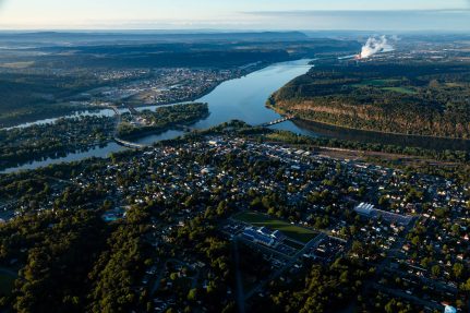 An aerial view of a large city on the shore of the Susquehanna River.