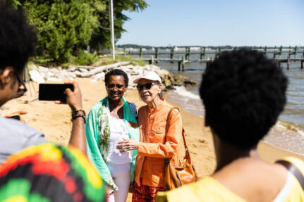 Two elderly African American women pose for a photo at Elktonia Beach