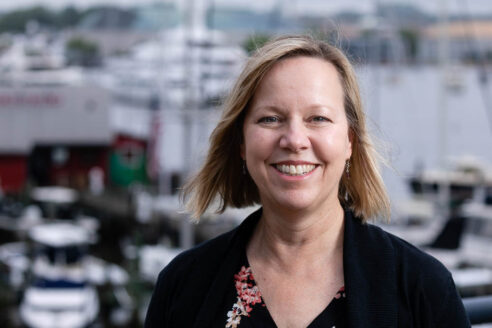 Martha poses in downtown Annapolis, with boats docked in the background.