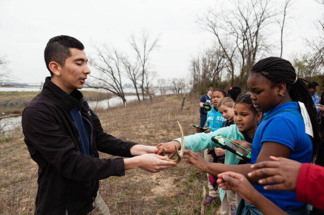 Educator shows students a pair of antlers