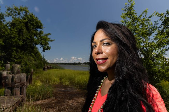 Nikki Bass faces the camera with the Nansemond River behinder her.