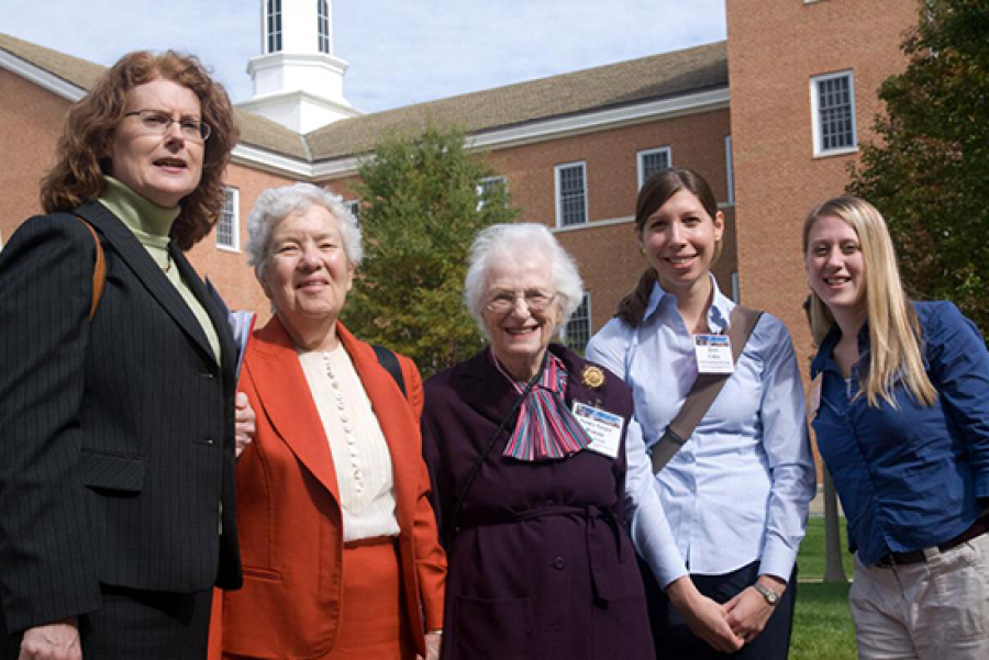 Five women stand in front of a building.