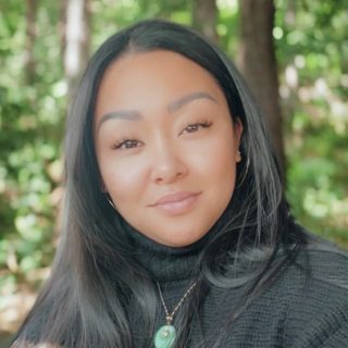 Women with dark hair standing outside