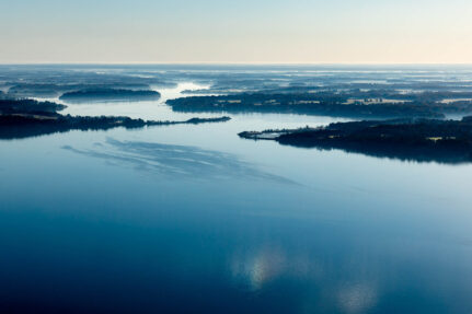 Aerial view of river with land to the side.