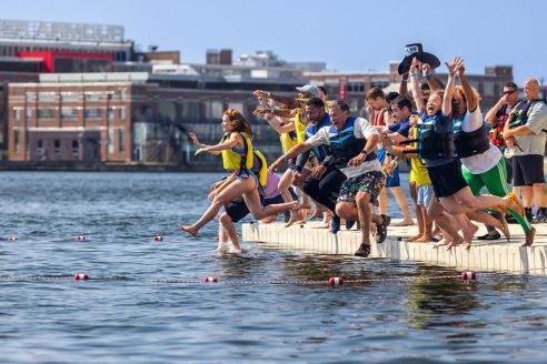 Swimmers leap en masse into Baltimore's Inner Harbor