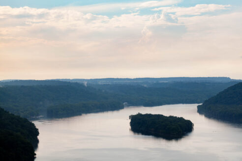 Aerial view of the river with land to the side.