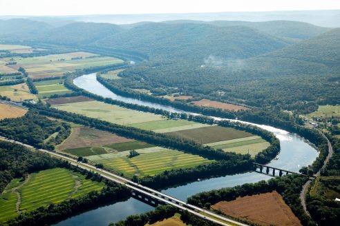 Aerial photo of a river winding through farmland and forest.