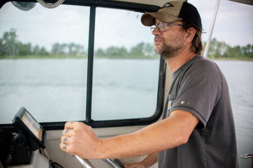 Military veteran Daniel Knott steers a boat on the Chesapeake Bay.