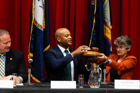 A photo of Wes Moore receiving the gavel from Janet McCabe during the Chesapeake Executive Council Meeting