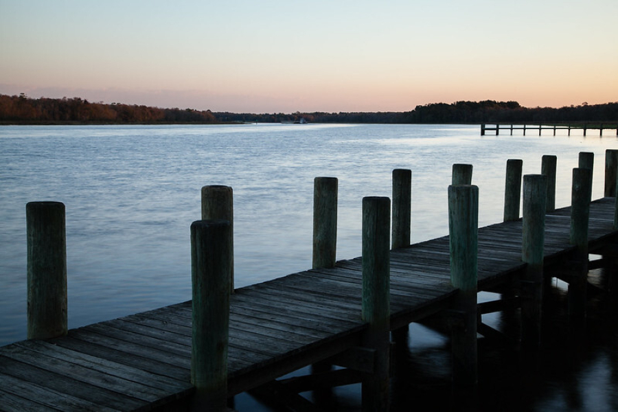 A pier and the water at sunset