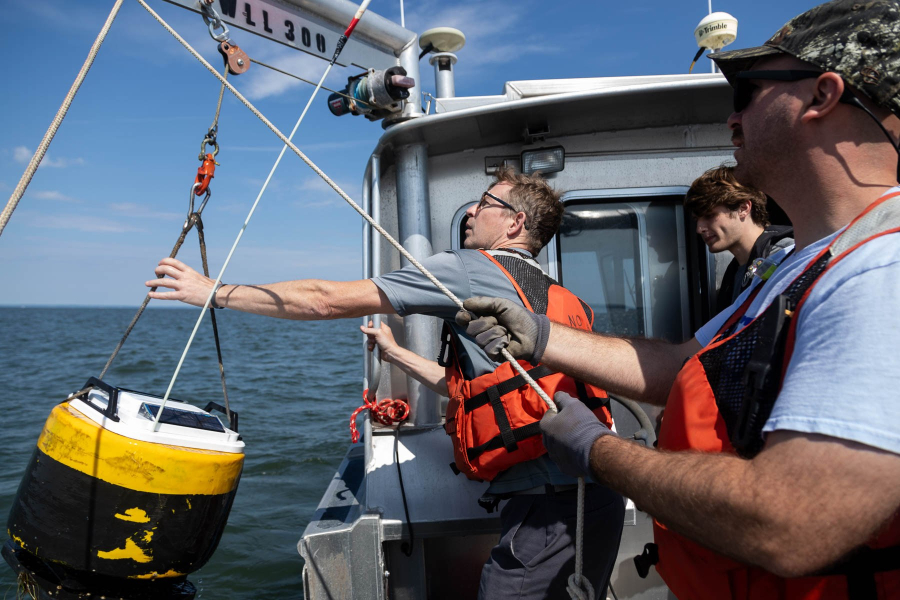 A crew from NOAA launches a buoy to measure hypoxia in the Chesapeake Bay.