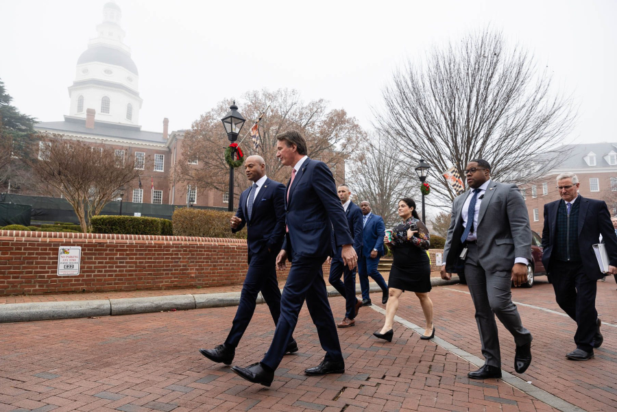 Governors and official walk with the Maryland State House visible behind them.