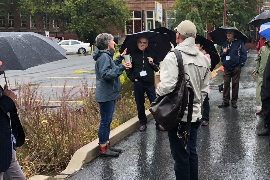 Local planners stop at a green infrastructure site in Lancaster, in the rain.