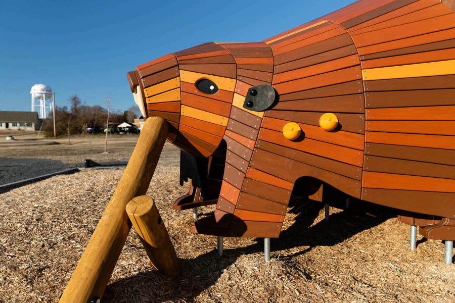 A large construction of a beaver made of wood.