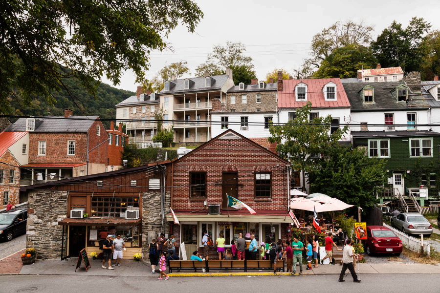 People walk past a building in Harpers Ferry.