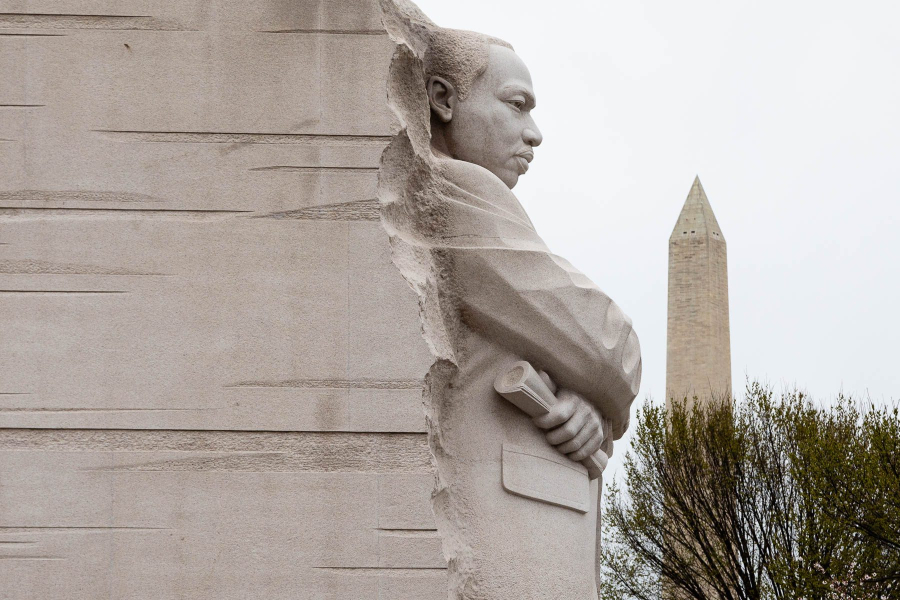 The stone profile of Martin Luther King, Jr., stands facing the Washington Monument.