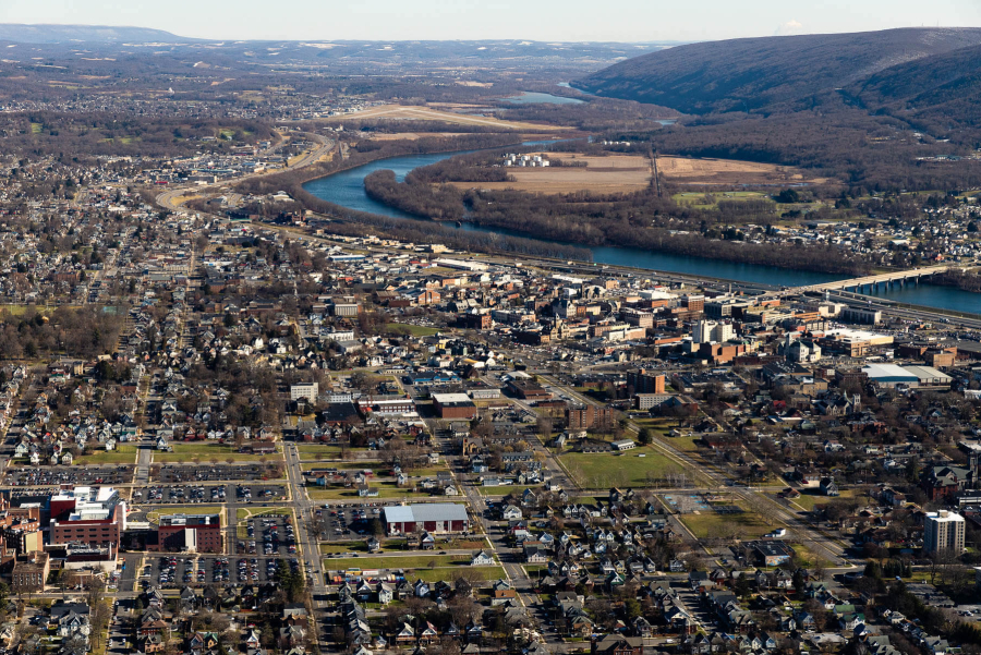 Aerial view of river winding through a highly developed area.