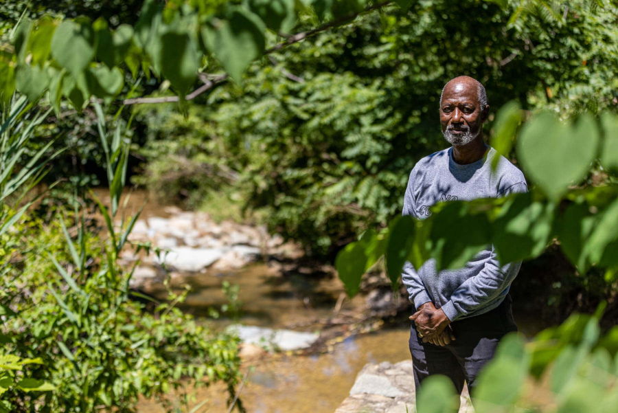 Dennis Chestnut poses by Watts Branch.