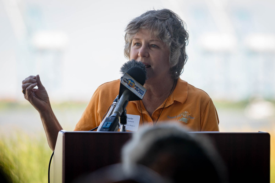 Marjorie speaks at a podium.