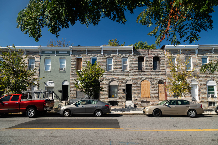 City street in Baltimore City shows few trees.