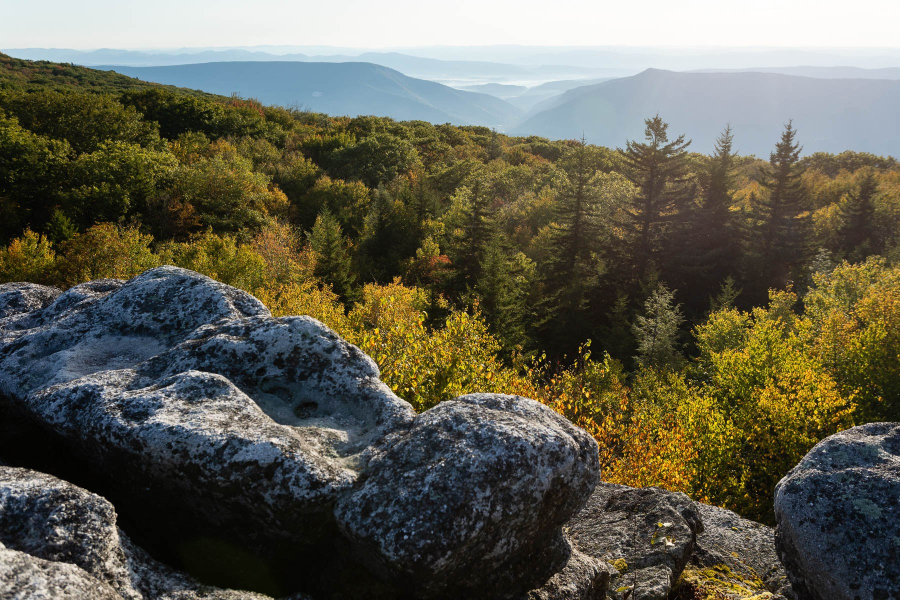 Rocks in the foreground look out at a scenic vista.