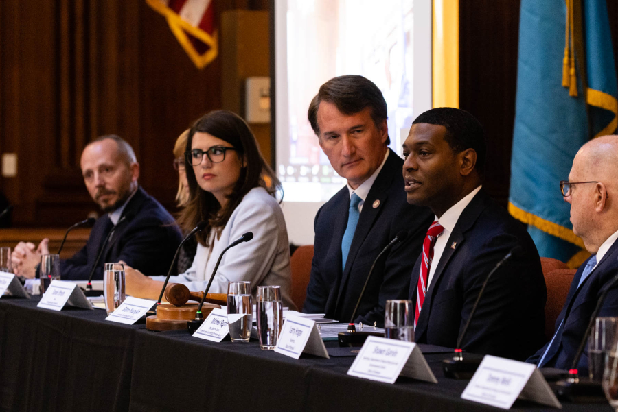 Administer Regan speaks while surrounded by other Executive Council members.