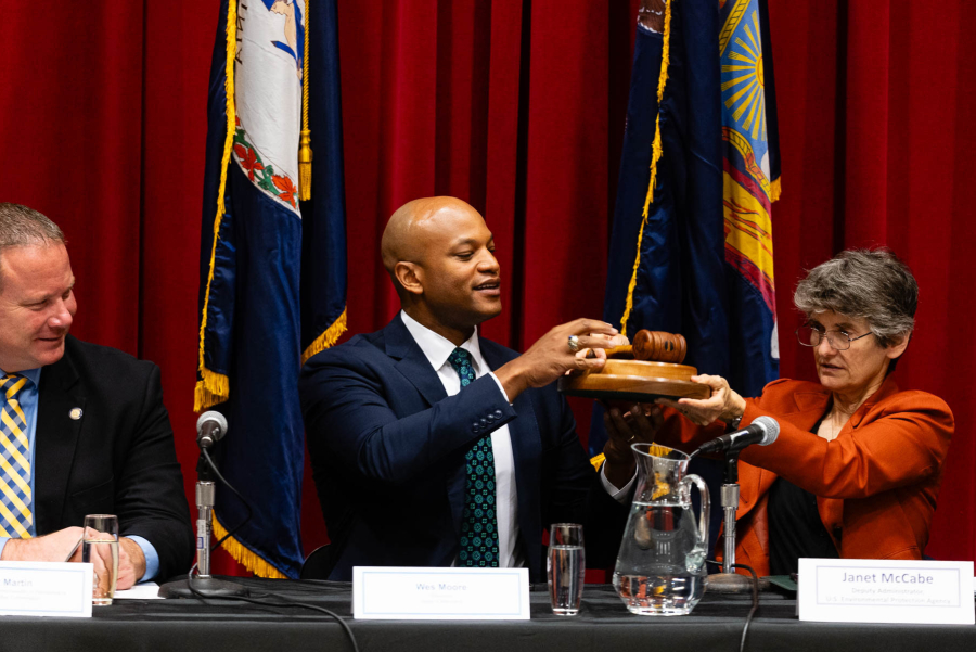 A photo of Wes Moore receiving the gavel from Janet McCabe during the Chesapeake Executive Council Meeting