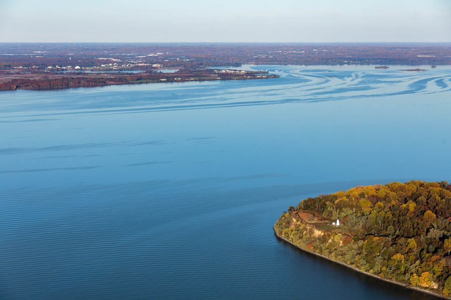 Turkey Point Lighthouse seen from above, surrounded by water and forest.