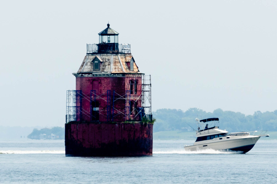 A boat passes Sandy Point Shoal Lighthouse.