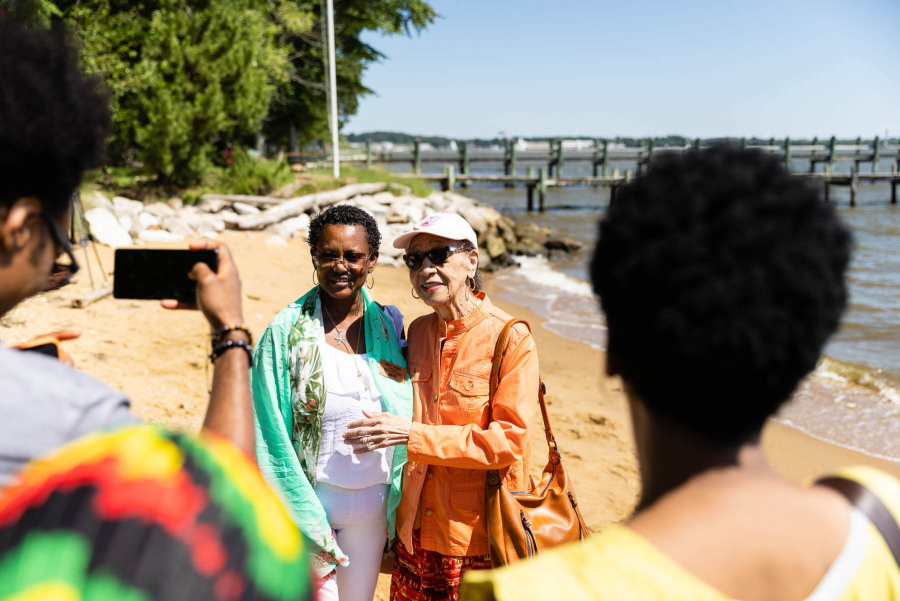 Two elderly African American women pose for a photo on the Ektonia beach.