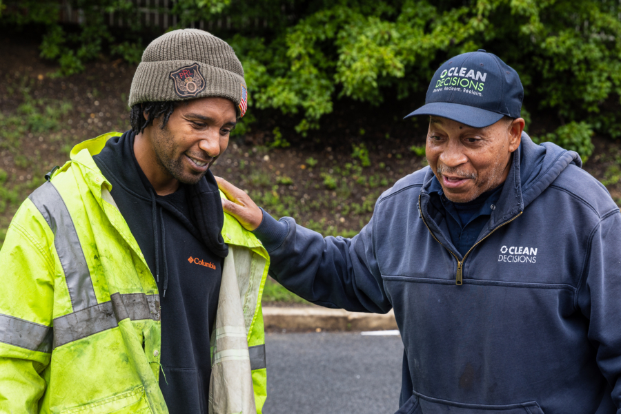 Ferrell, a generation older than Charles, lays one hand on the younger man's shoulder as they talk